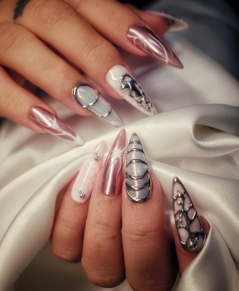 Close-up of long almond nails with rose chrome and silver line art