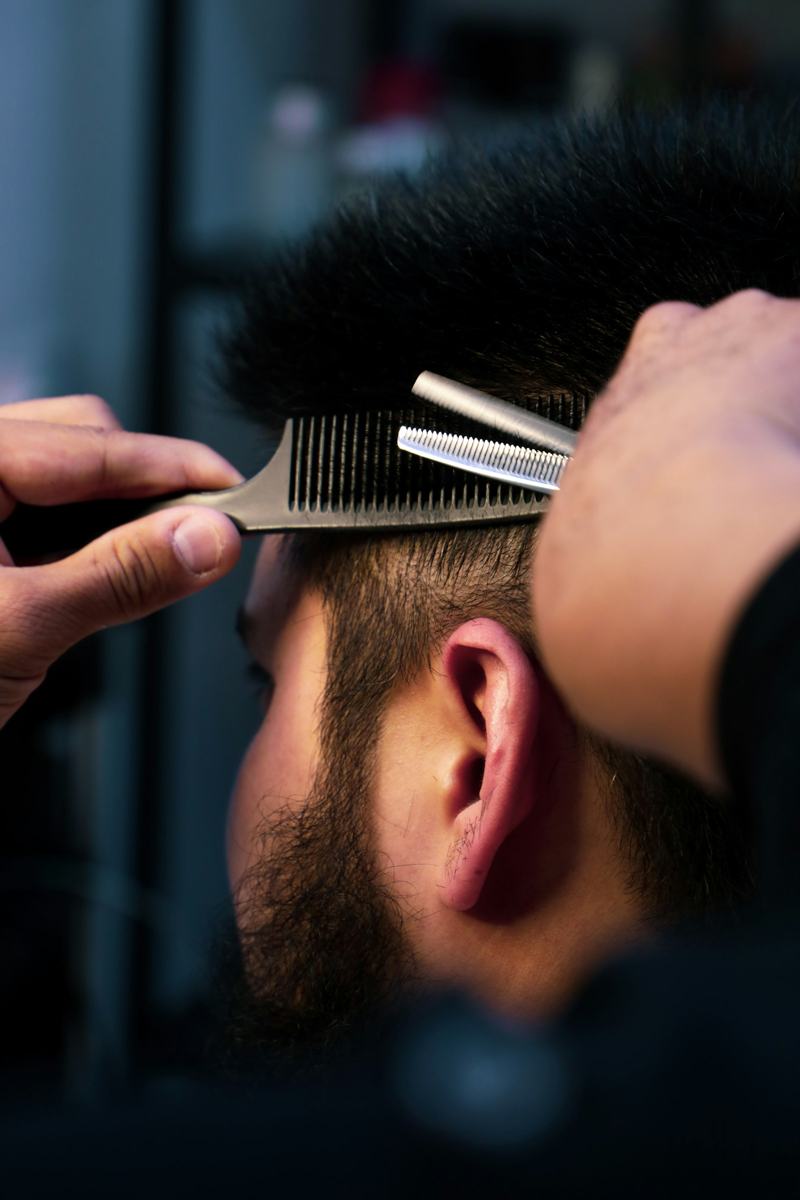 Close-up of clippers on the side of a client's head